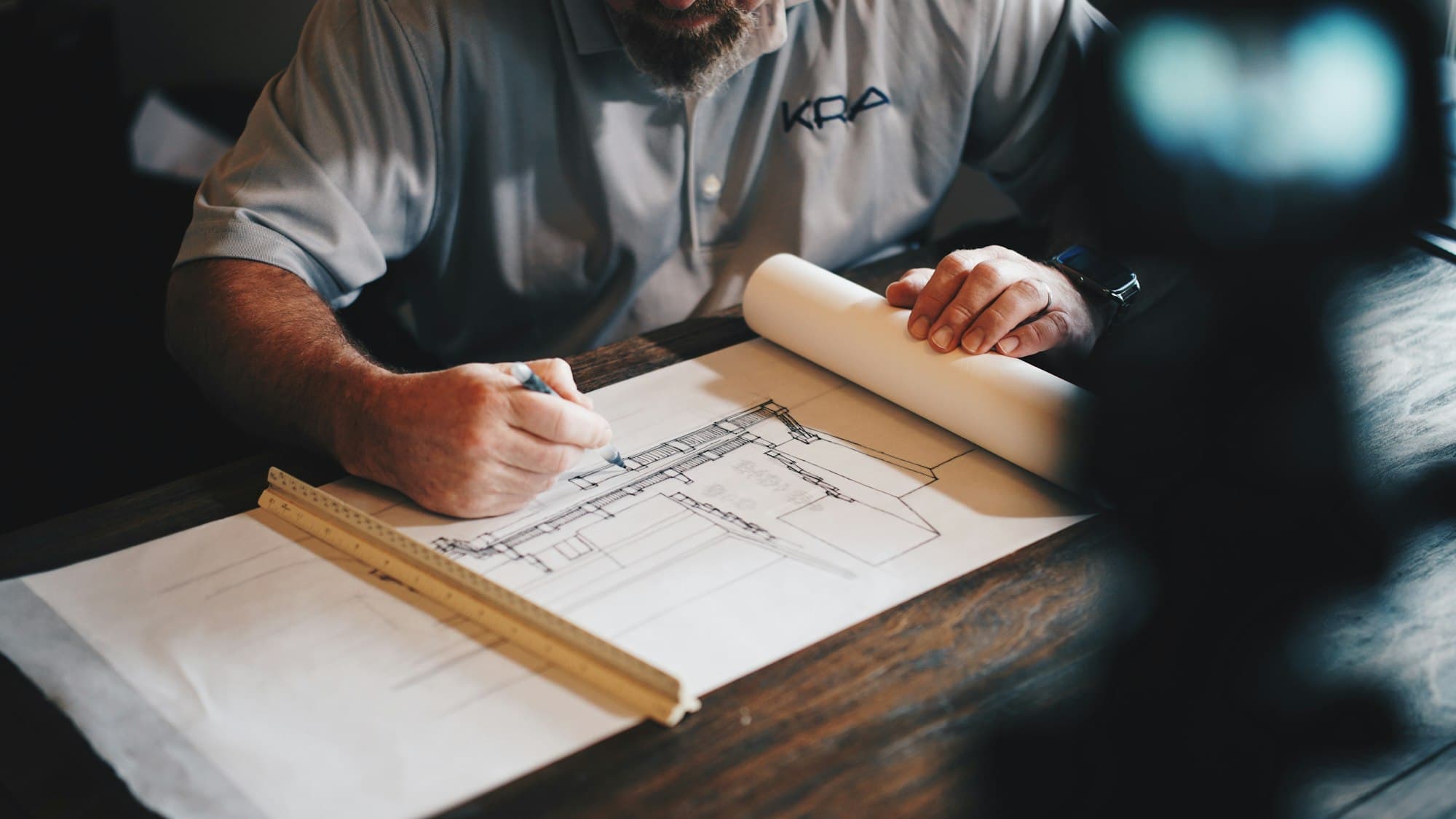 Construction drawing being worked on at a drawing table