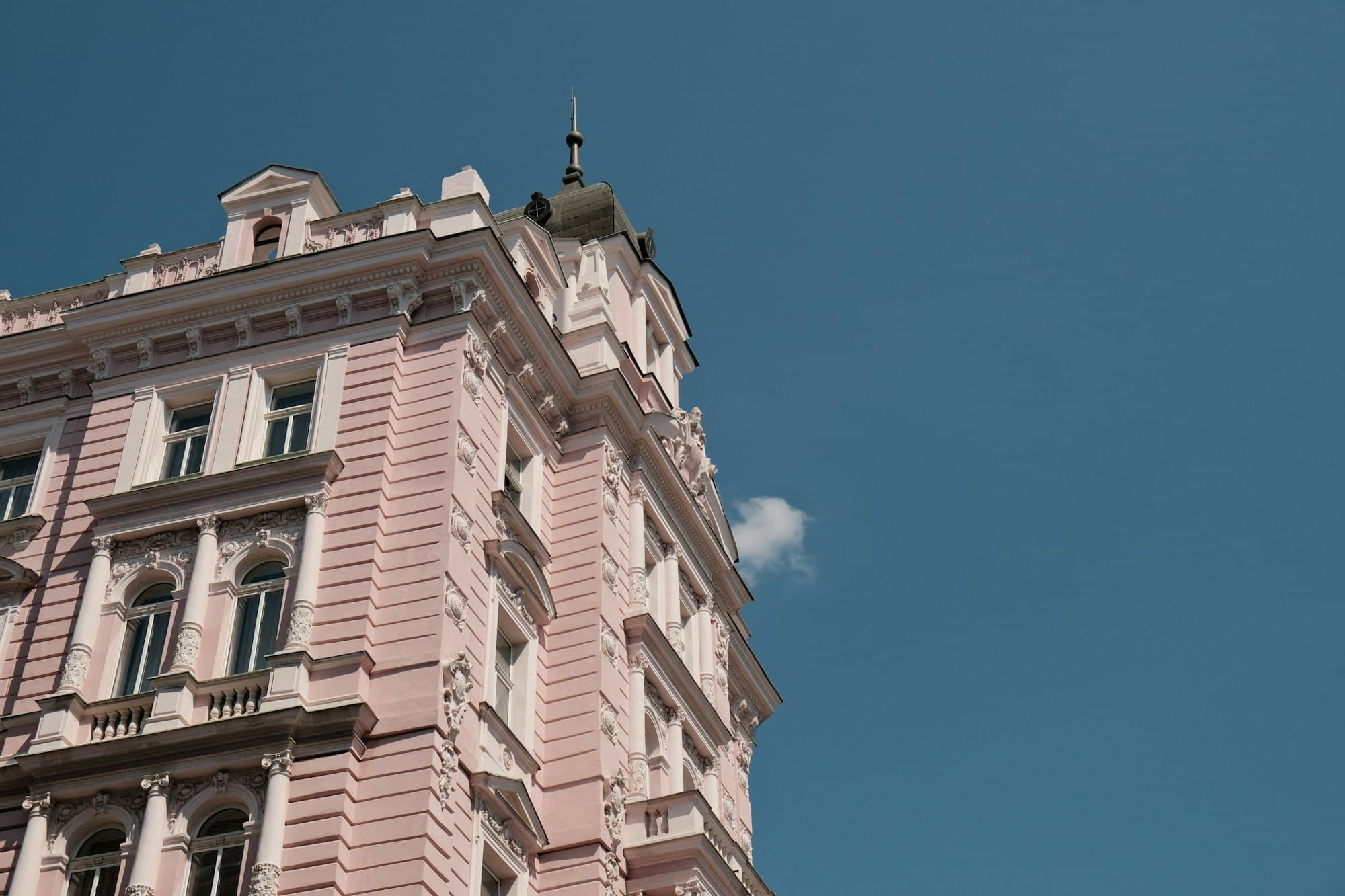Historic facade with stucco ornaments and a corner tower