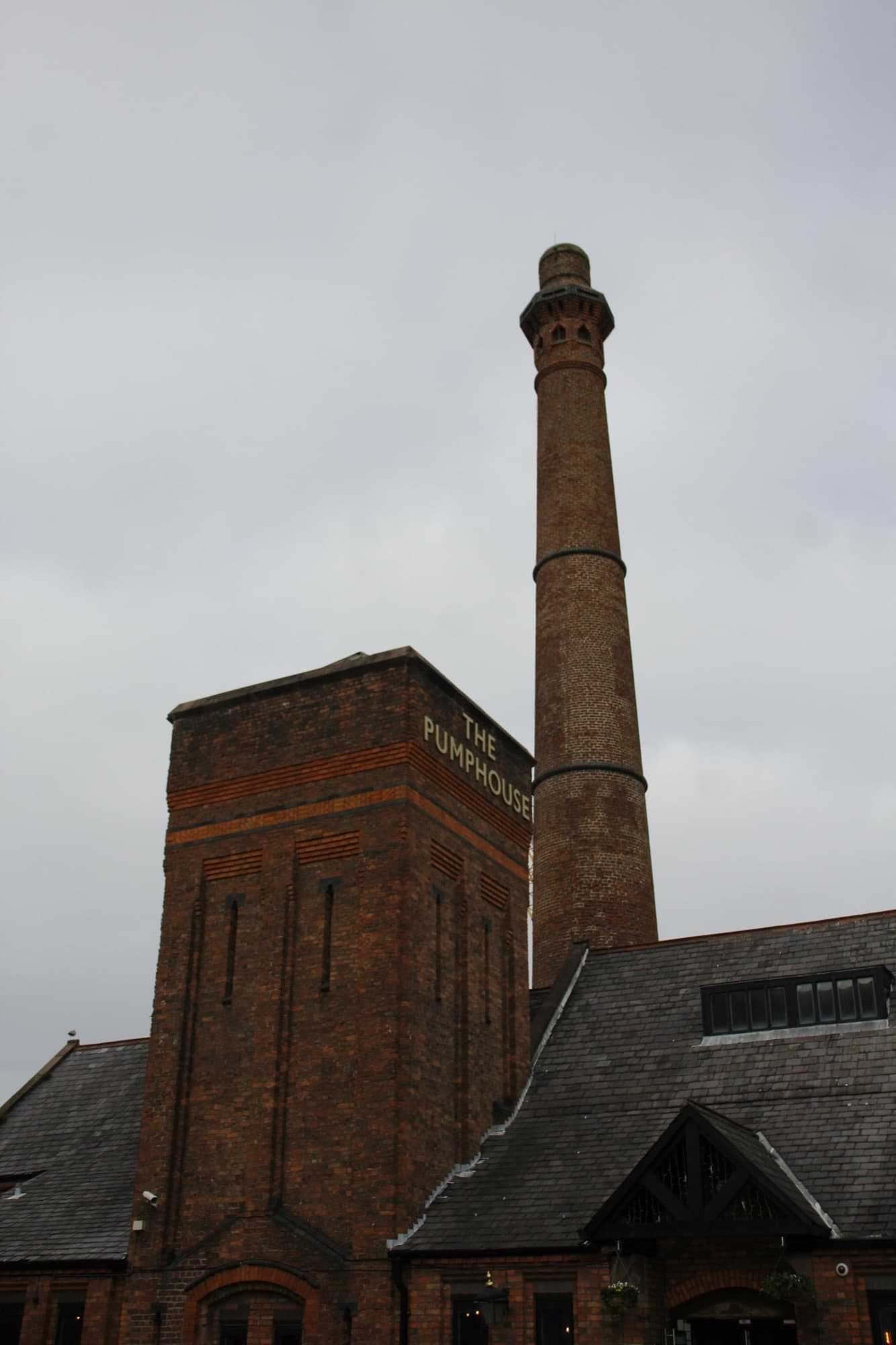Brick industrial building with a tall chimney