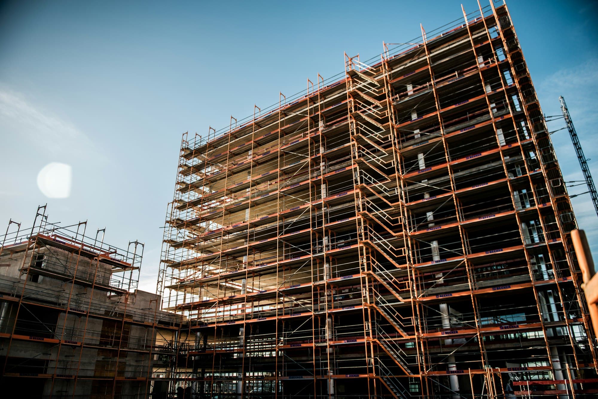 Scaffolded building shell against the light
